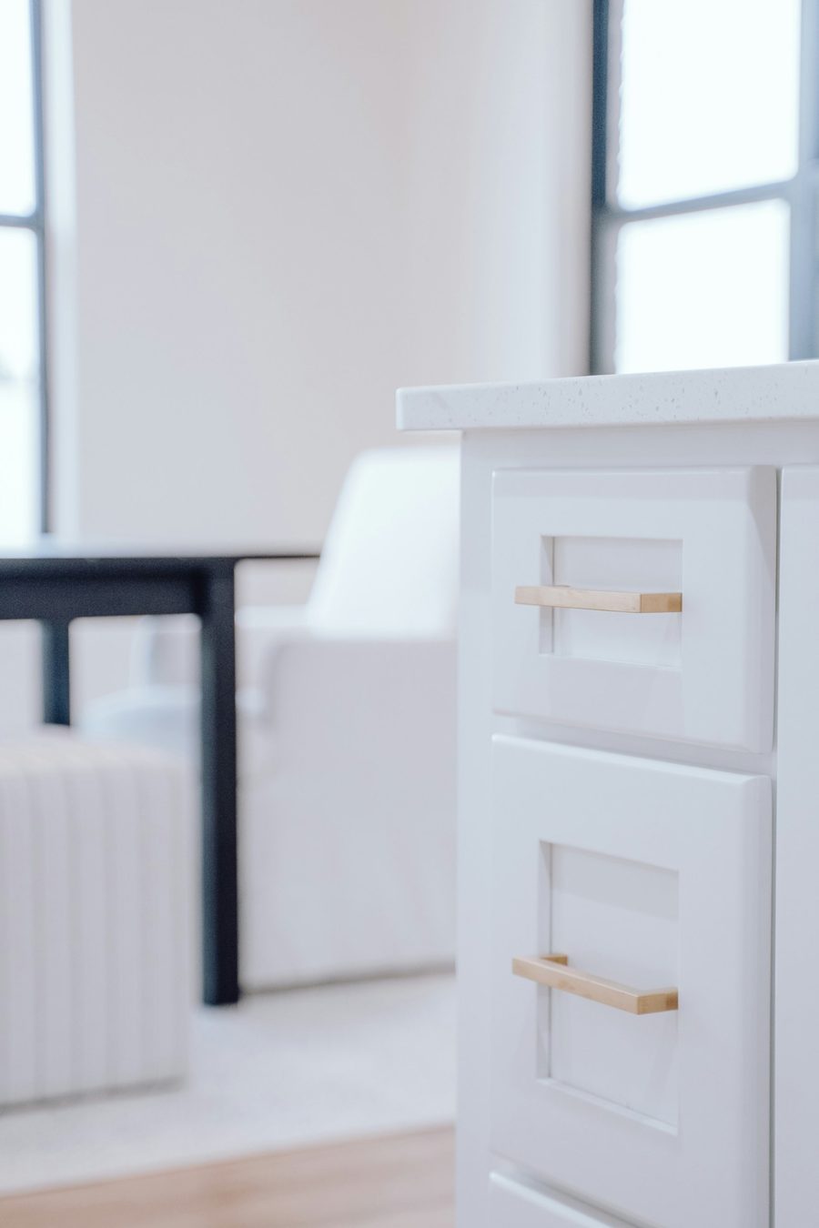 White kitchen cabinet with brass handles