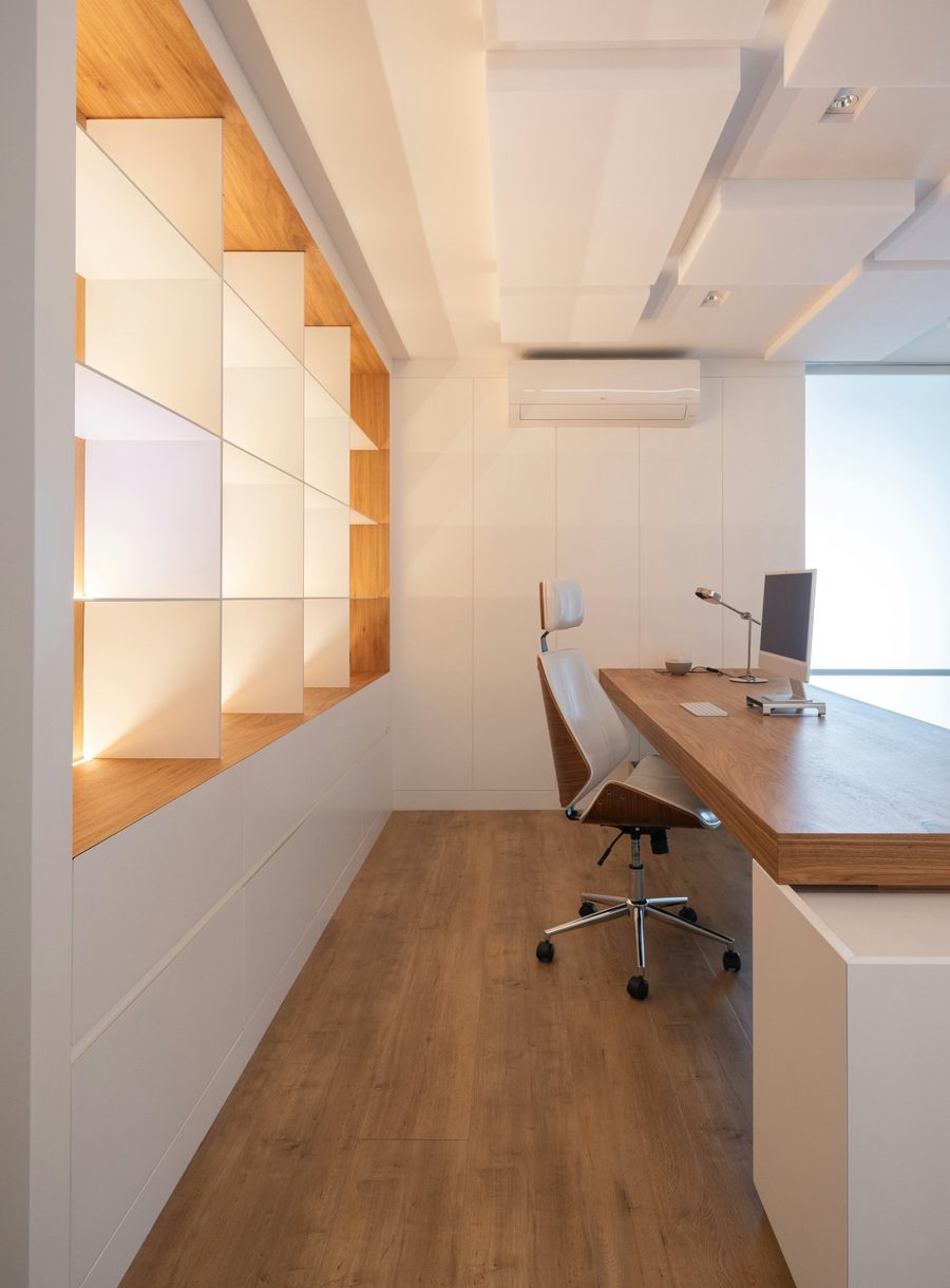 Clean modern office with wooden desk and chair
