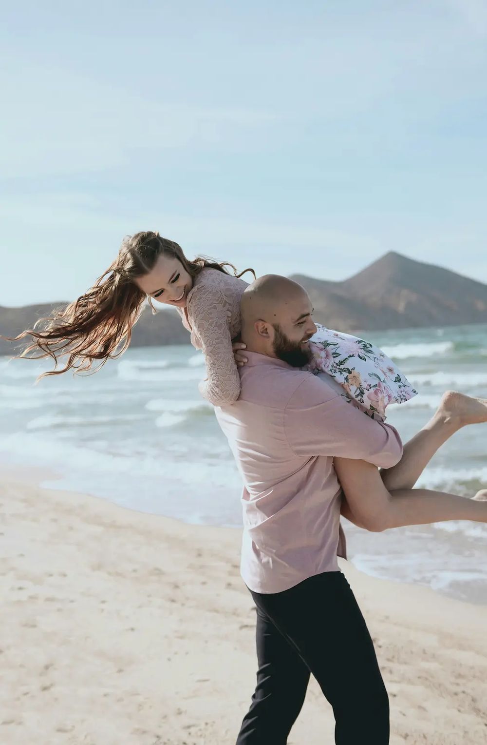 Thom lifting Cindy on the beach
