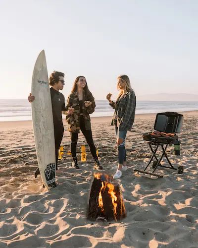 Friends around a beach bonfire