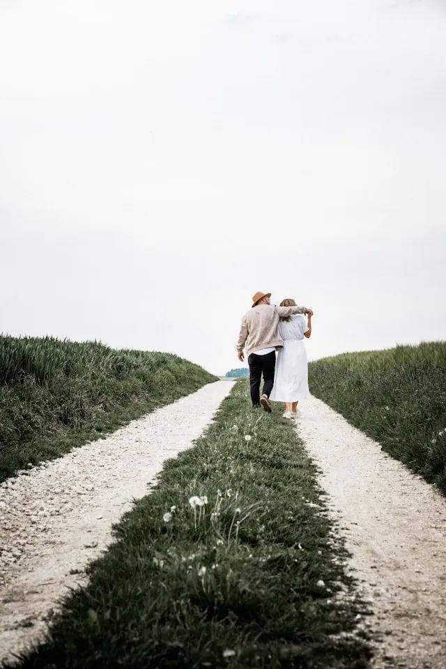 Cindy and Thom walking together down a country path